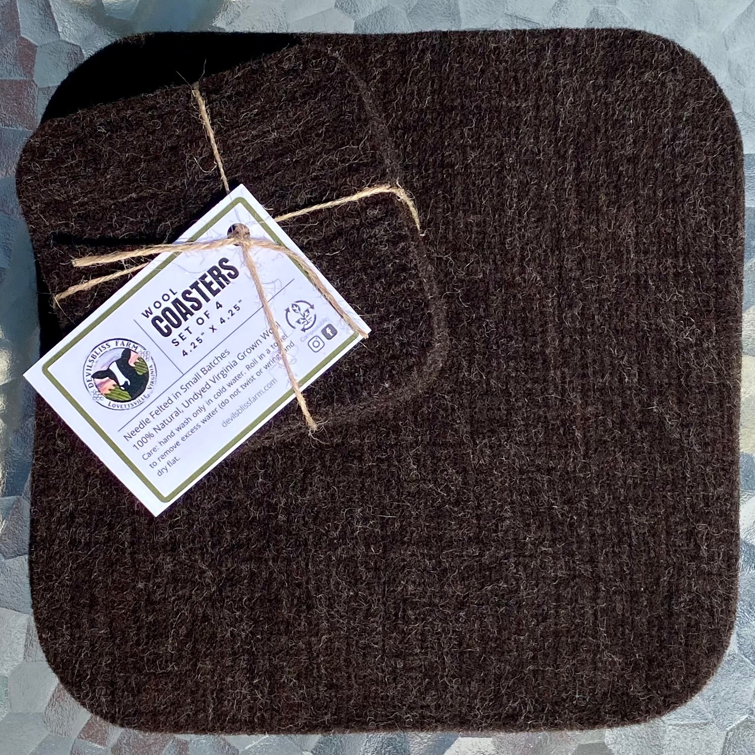 Dark brown coasters shown with dark brown hot pad. 100% Devilsbliss Farm wool. Coasters are reversible.